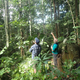 Natural history photographer Clay Bolt and writer Glen Chilton examine a termite mound while searching for Wallace’s giant bee.